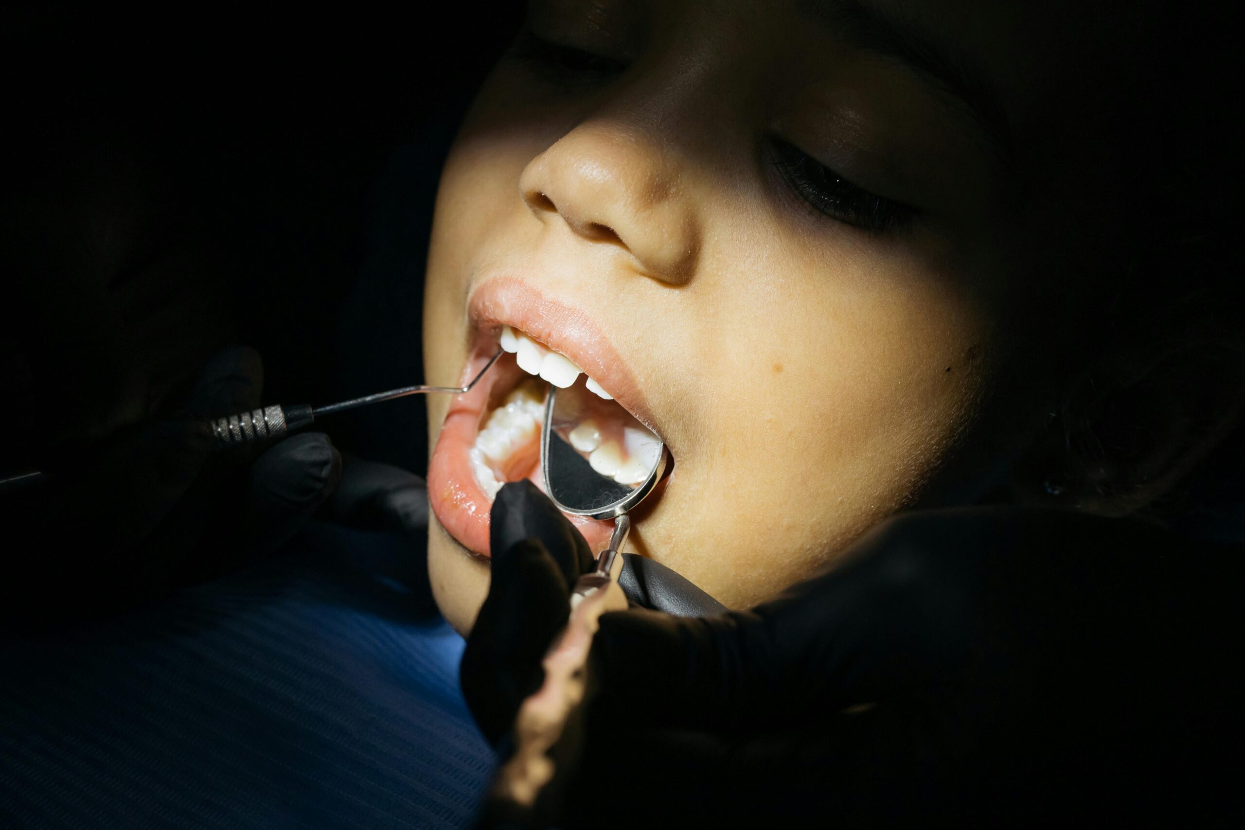 patient undergoing treatment + measuring gums as part of periodontics near me